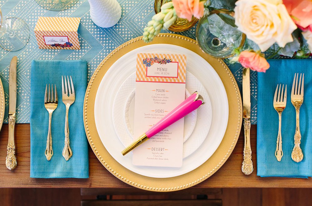 Colorful spring tablescape wedding design with floral centerpiece