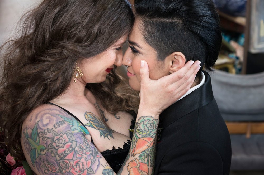 LBGTQ tattoos offbeat couple kiss interracial marriage 