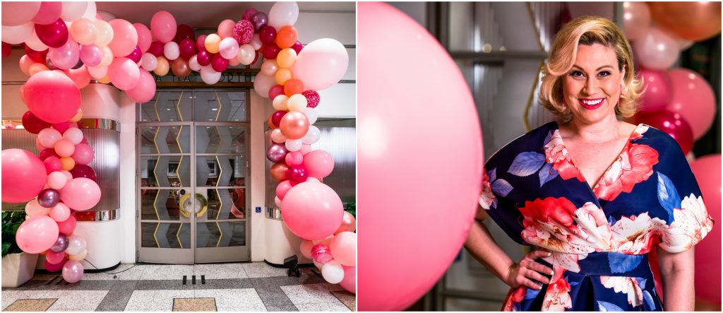 pink balloon display with women in floral dress