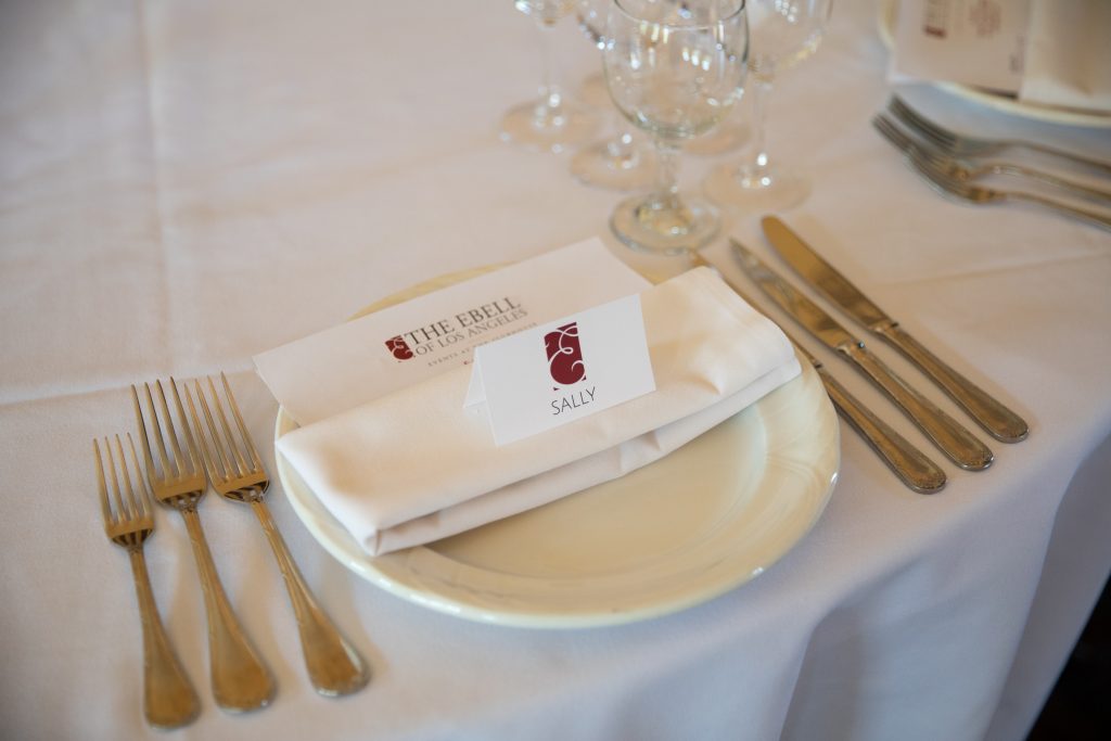 table place setting on white linen