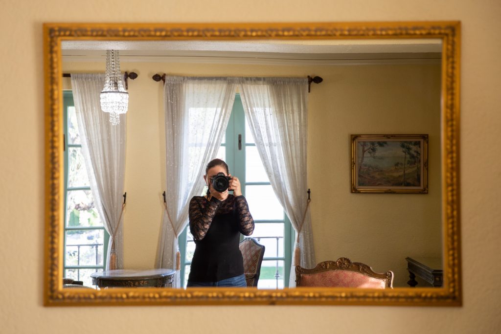 women taking photo in mirror