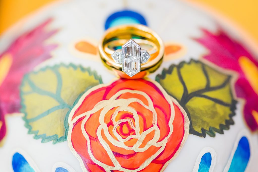 colorful wedding rings on sugar skull