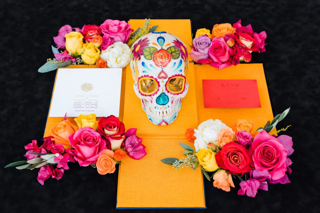 orange wedding invitation with skull and flowers