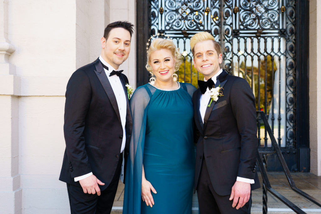 Wedding planner standing with couple in front of gate at The Ebell of Los Angeles 