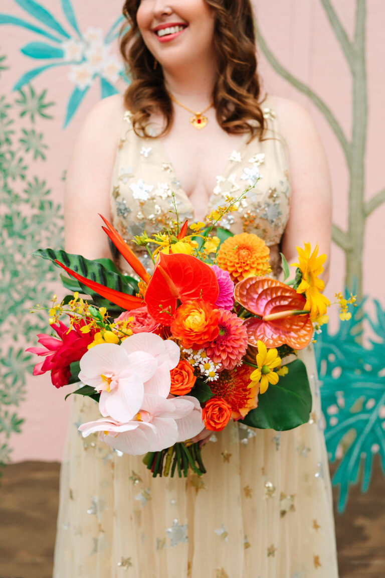 bride in gold dress holding wedding bouquet
